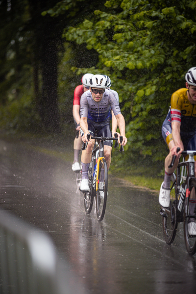 Two men racing on bikes with one in a grey shirt and the other in yellow.