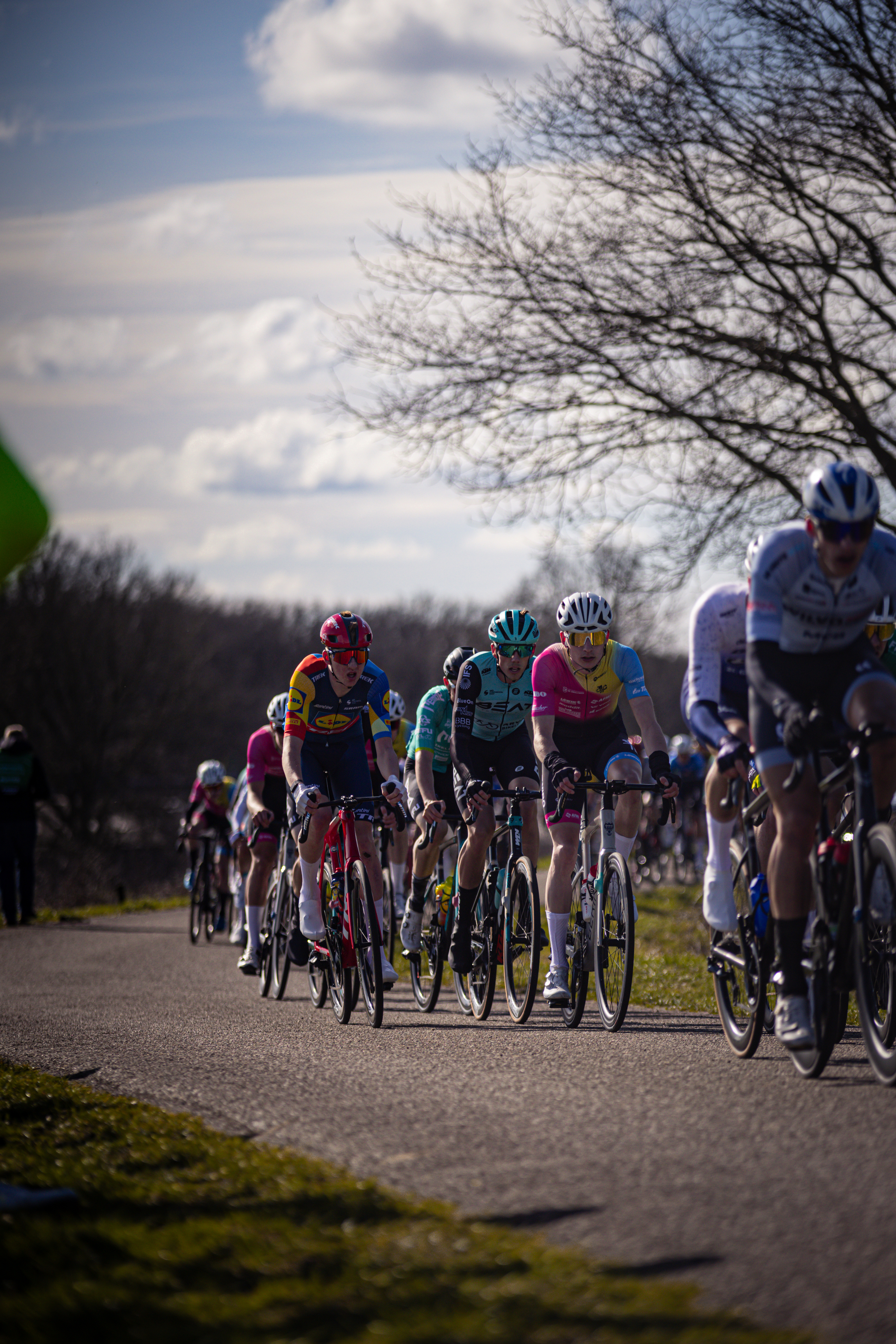 A group of cyclists race down a street in the Netherlands.