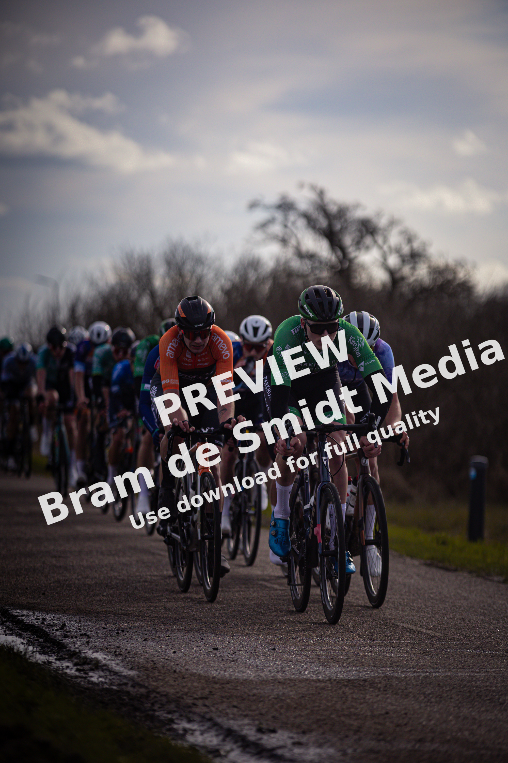 Several cyclists in a race, including number 3 and 4.