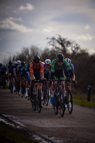 Several cyclists in a race, including number 3 and 4.