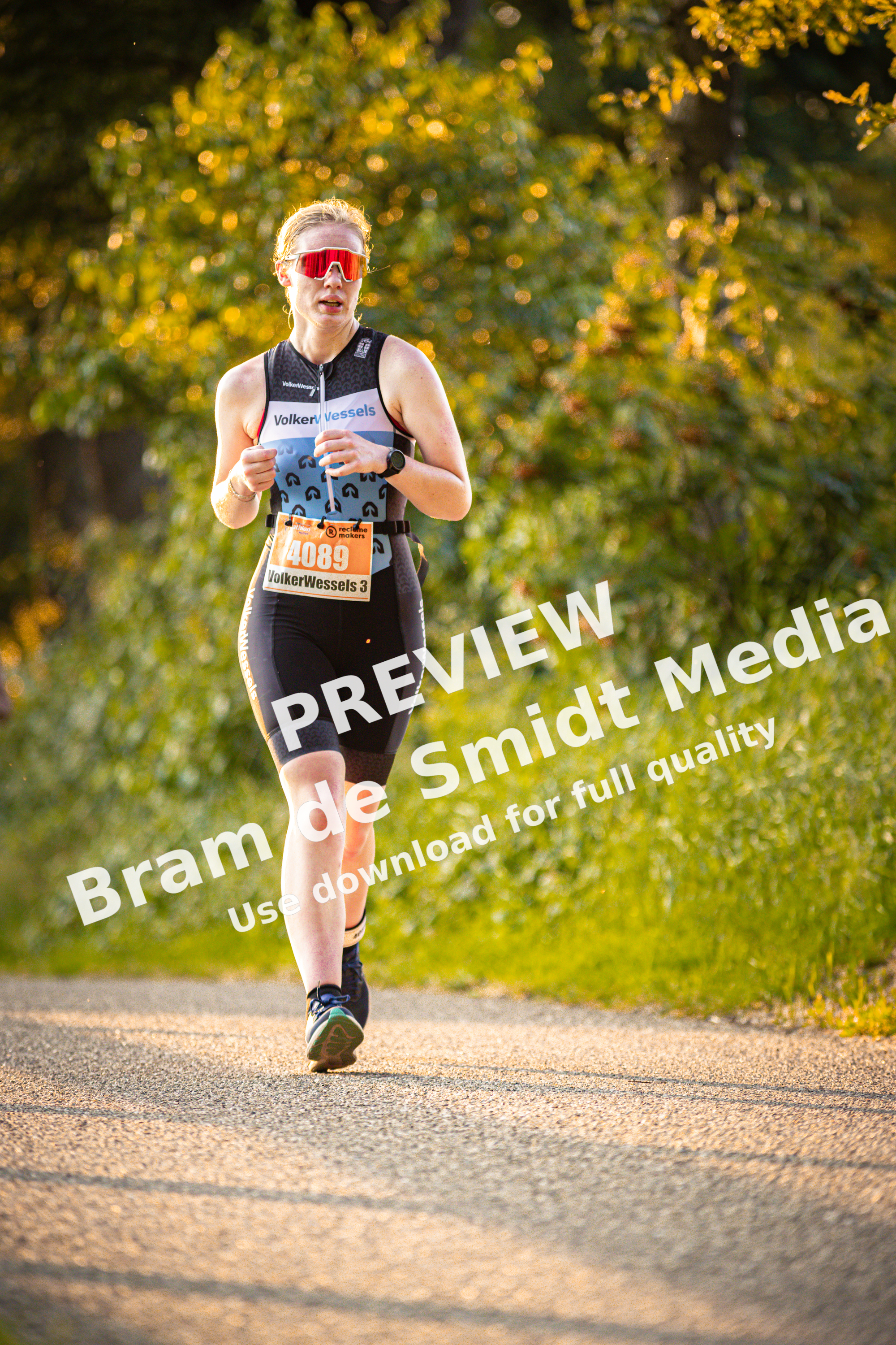 A runner on a trail with the word triathlon written on their shirt.