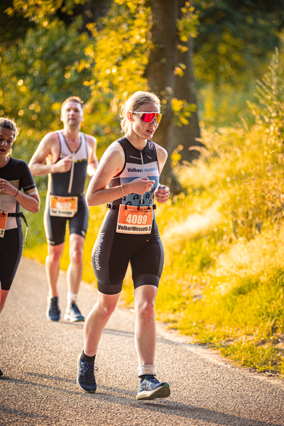 A person is participating in a triathlon with the number 6949 on their bib.