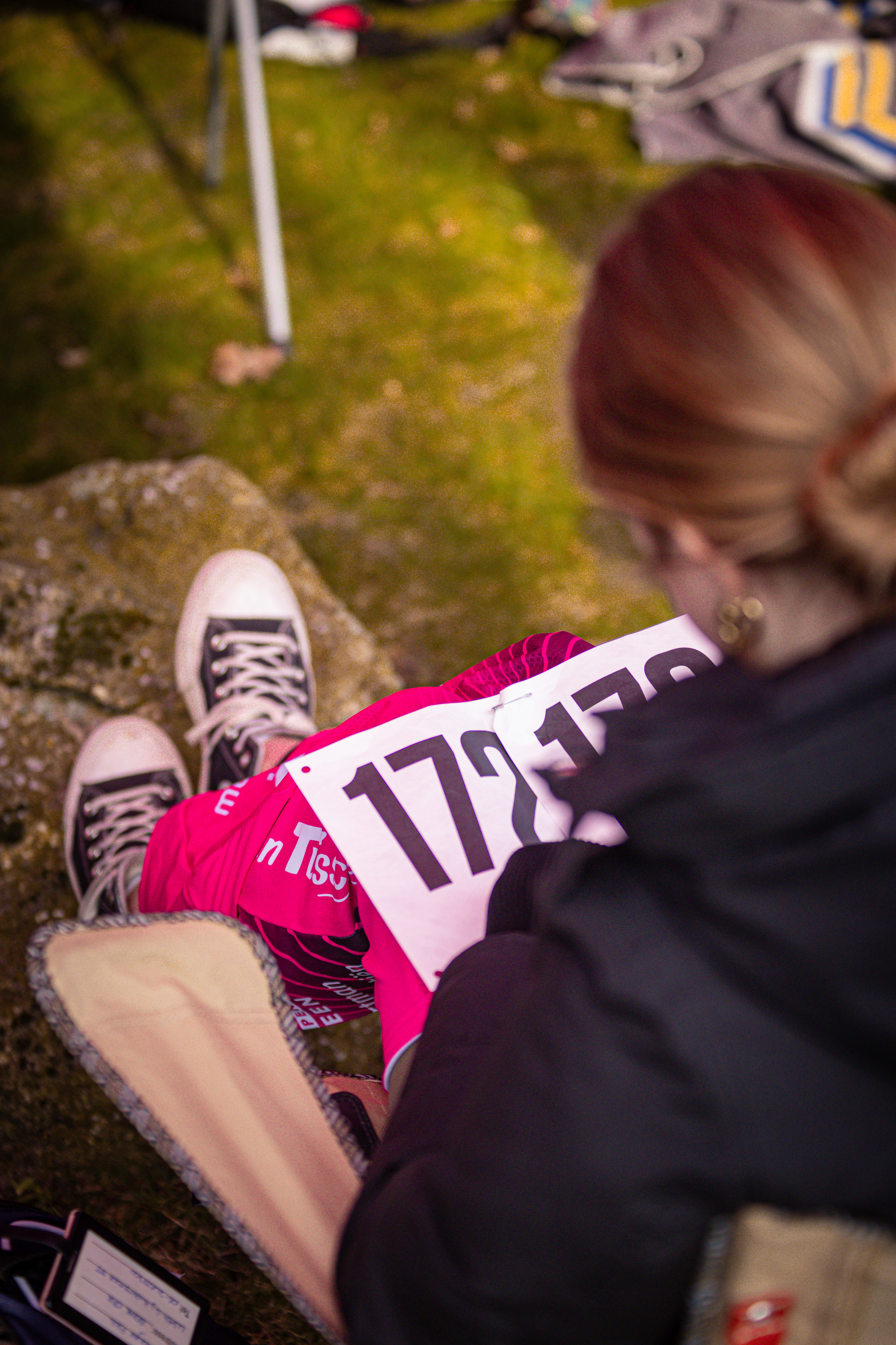 A person is holding a race bib with the number 1783 on it.