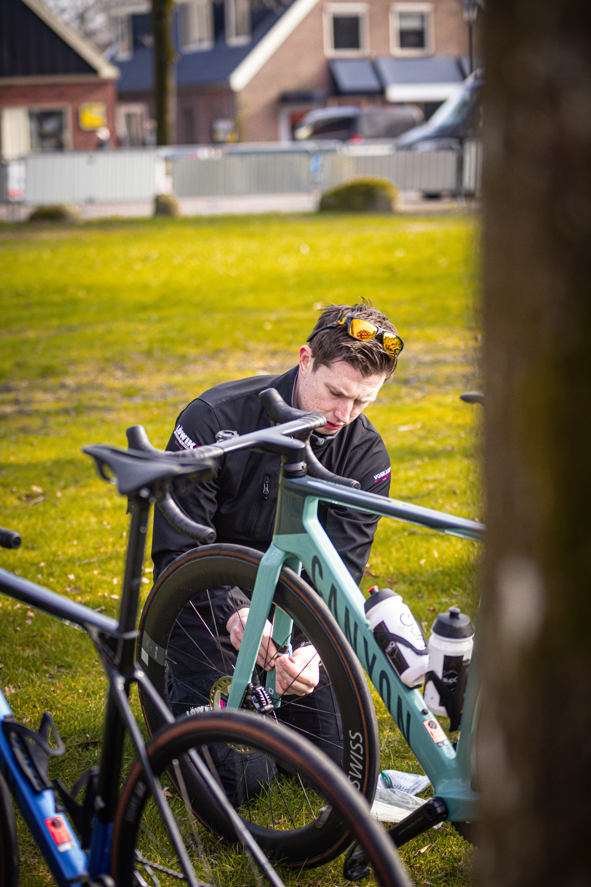 A man working on a bicycle in Drentse 8 van Westerveld.