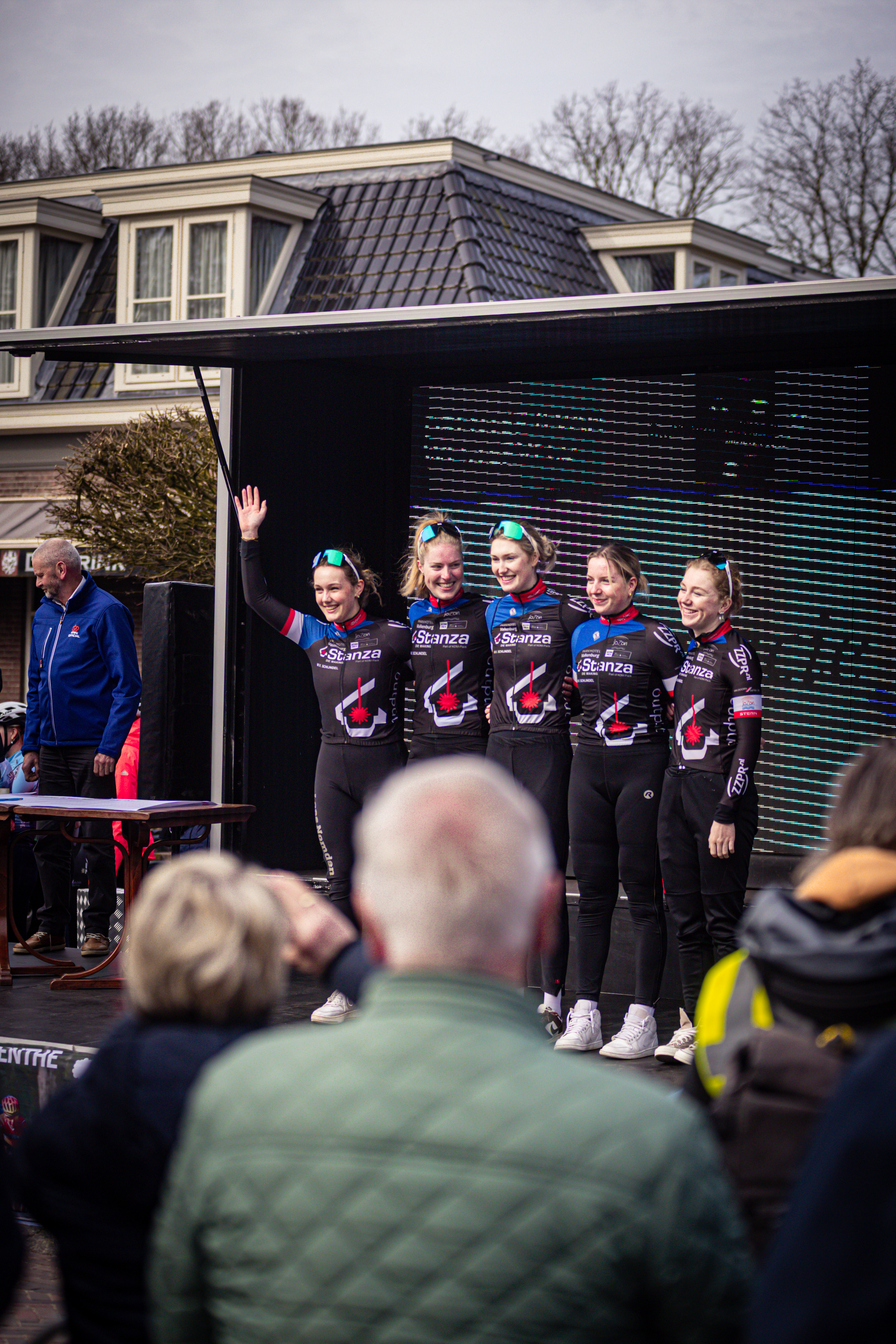 A group of athletes pose on stage at the Wielrennen event in Drentse.