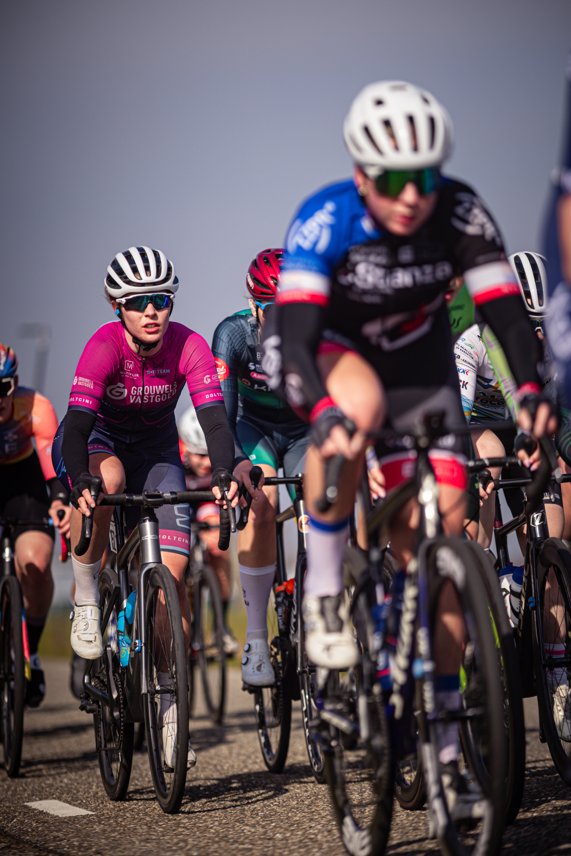 A group of cyclists are riding together in a race.