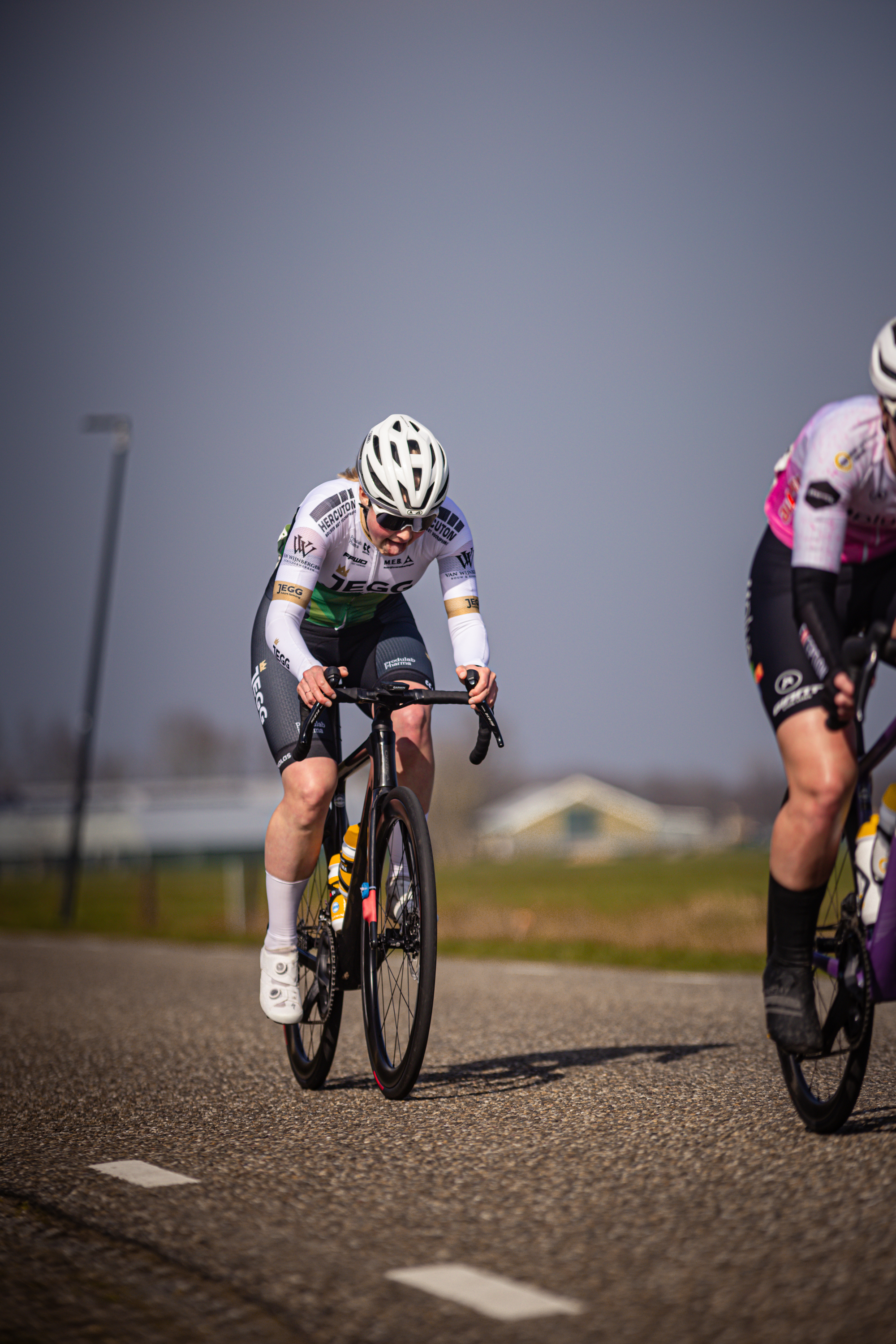 Two cyclists are on a road during the Drentse 8 van Westerveld race in 2024.