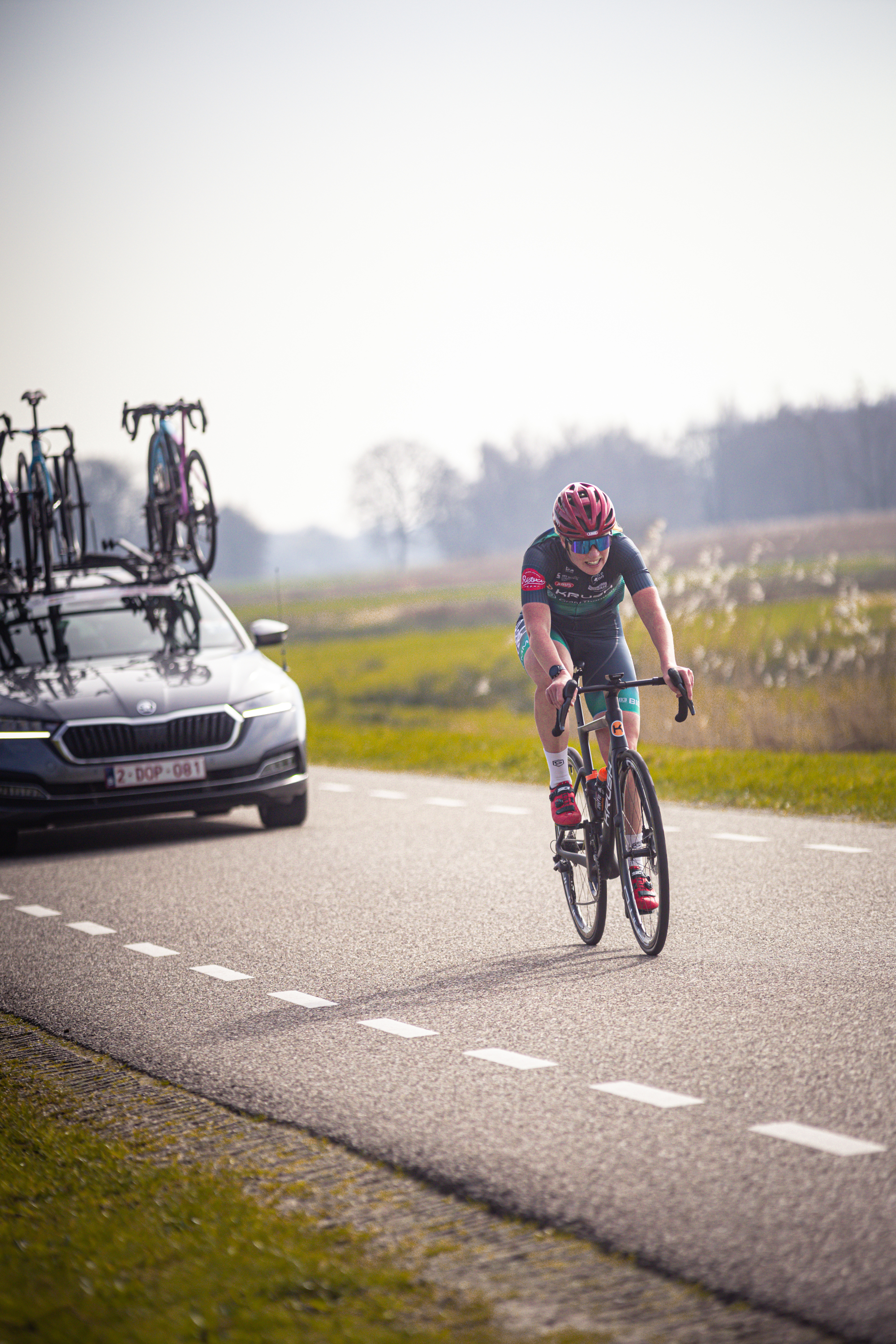 A person on a bike is wearing a jersey with the numbers 27 and 28 on it.