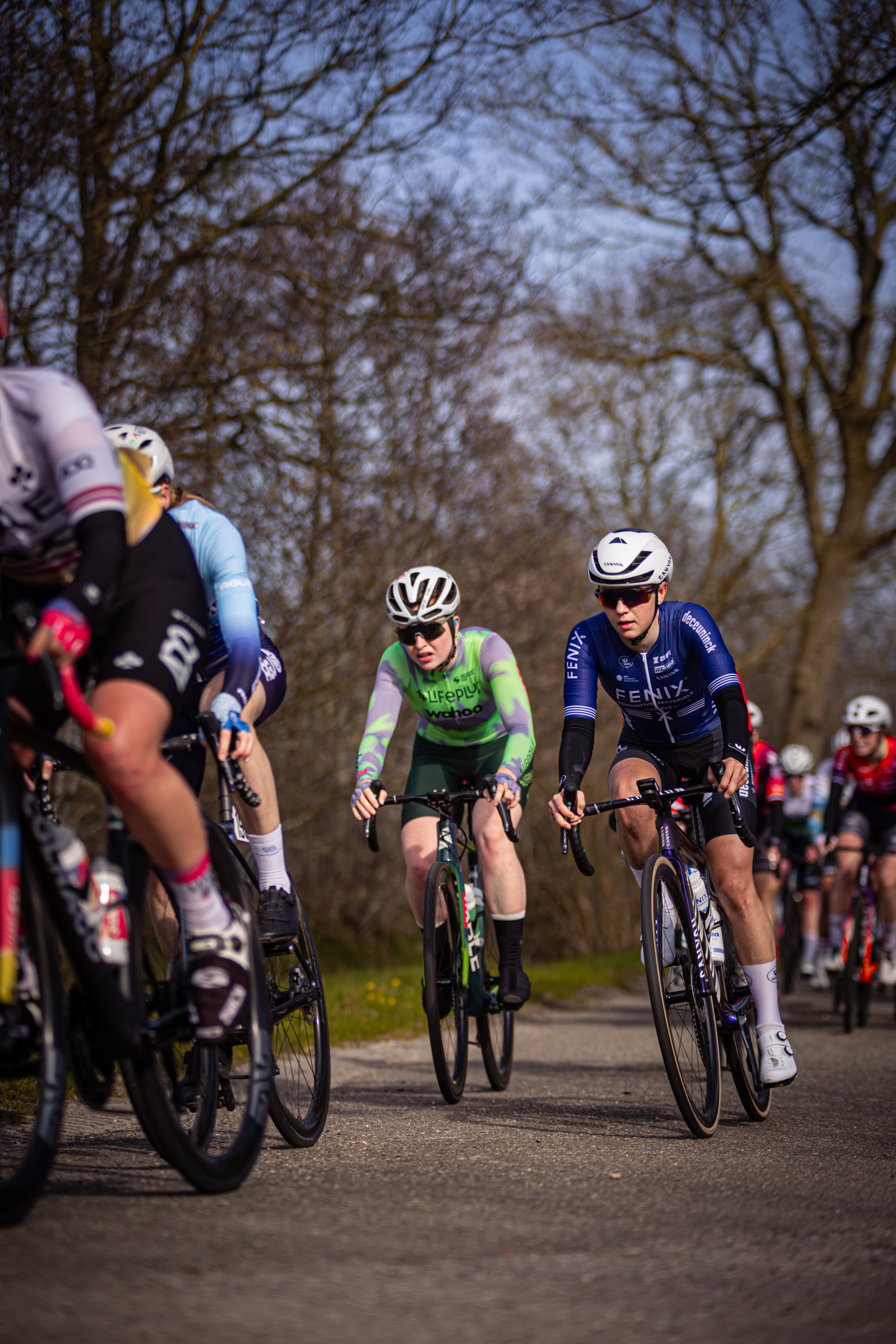 Two cyclists are participating in a race, number 21 and 23.