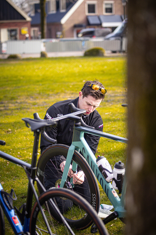 A man working on a bicycle in Drentse 8 van Westerveld.