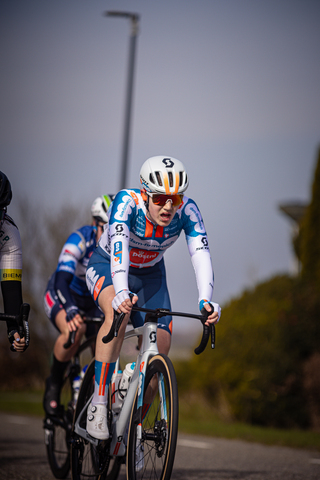 Three people are riding bikes in the Drentse 8 van Westerveld race.