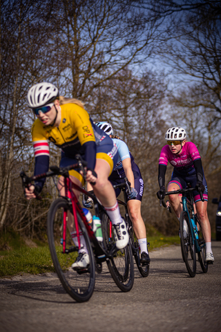 Three women race in a cycling event in the Netherlands.