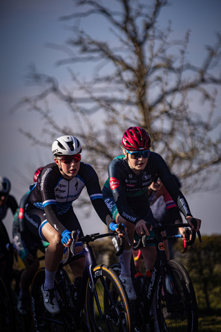 A group of athletes race through a wooded area in the Drentse 8 van Westerveld.