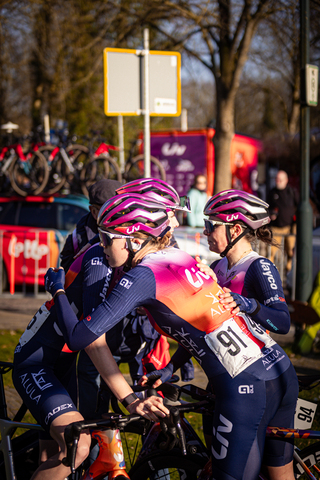 A group of cyclists with their helmets on and one wearing number 91.