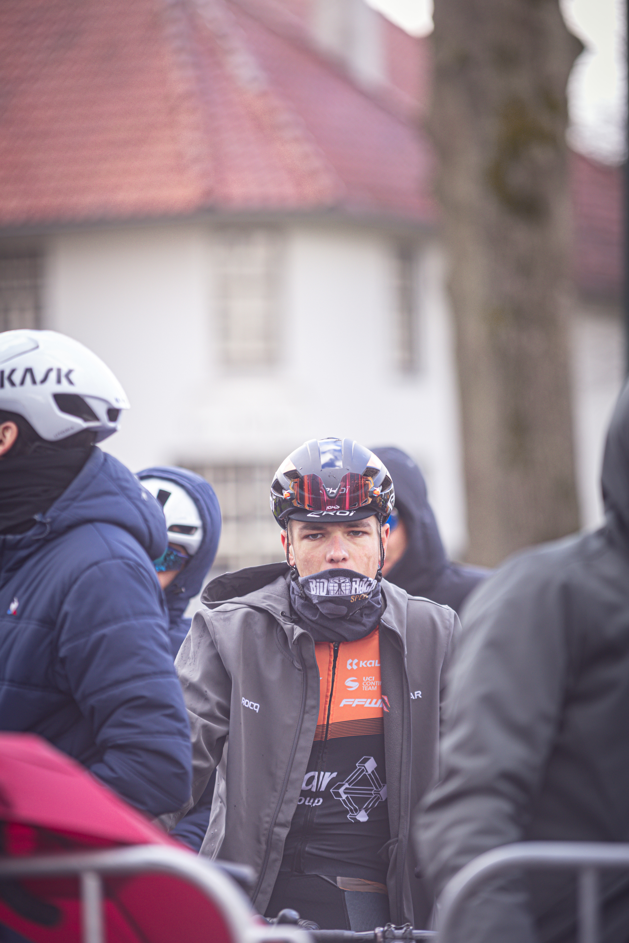 A person is at the 2024 Olympics Tour Stage 4, wearing a helmet and jacket.