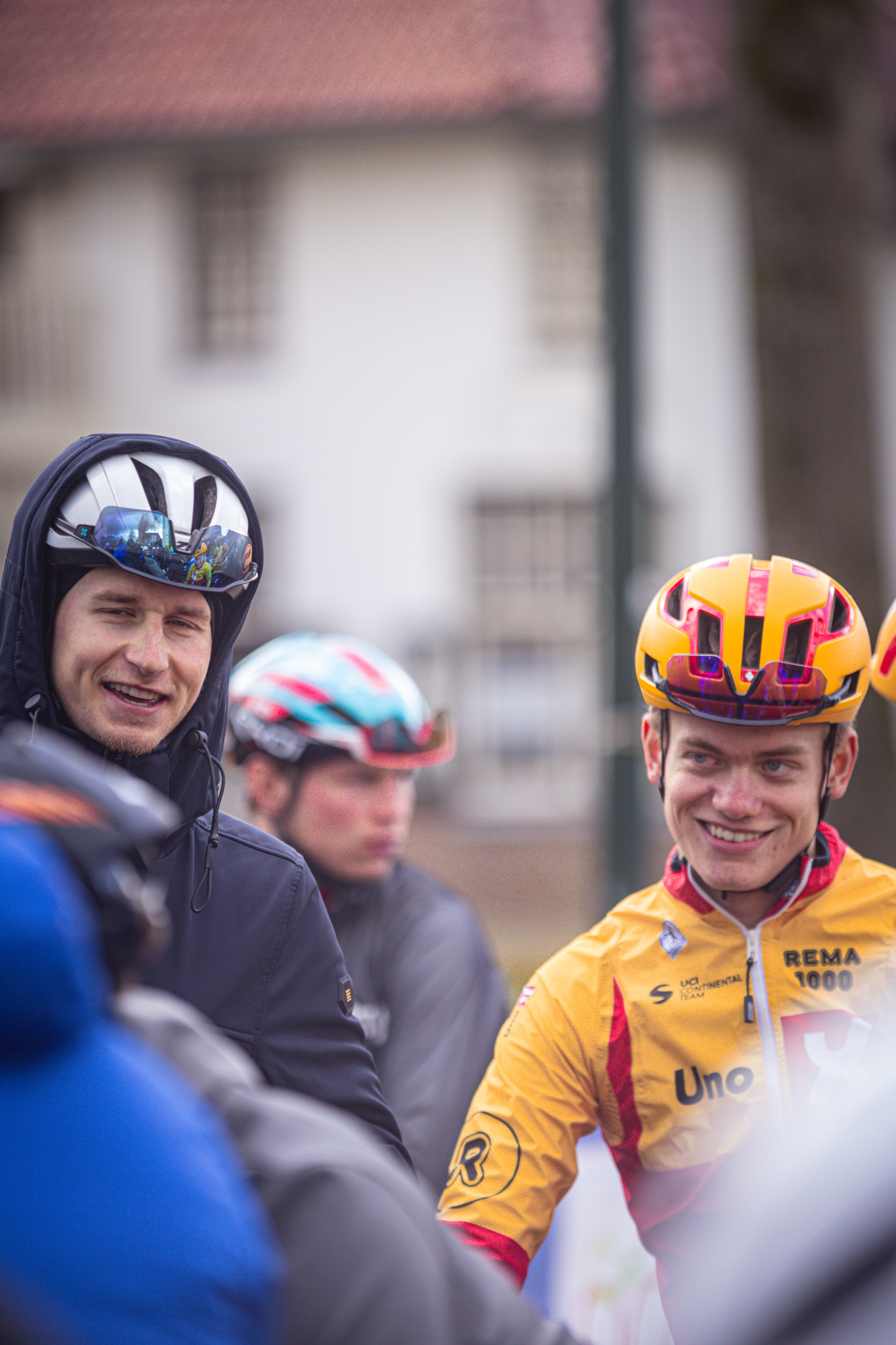 Two cyclists on a road with number 4 in the background.