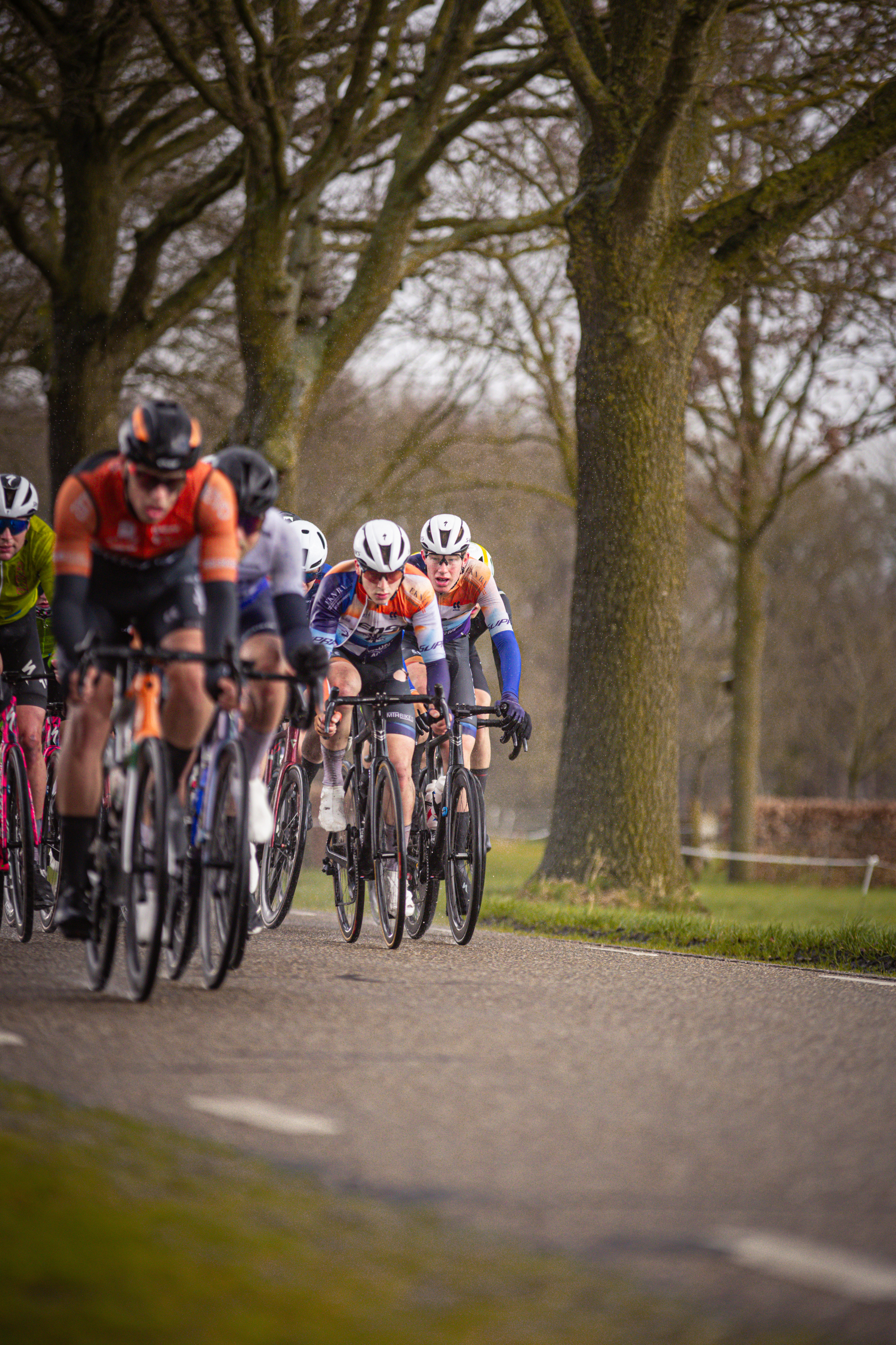 A group of cyclists in a race sponsored by Olympic Games.