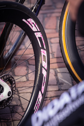 A close up of a bike tire with white writing on it.