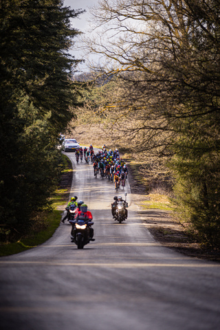 A group of cyclists are riding on a road during the Tour de France.