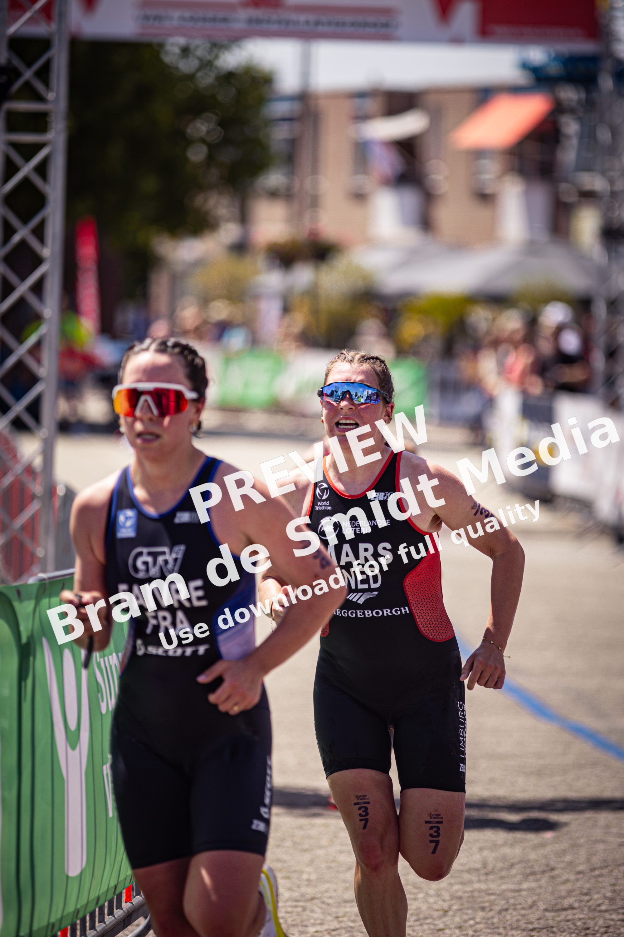 A woman running in a triathlon with the word Mars written on her uniform.