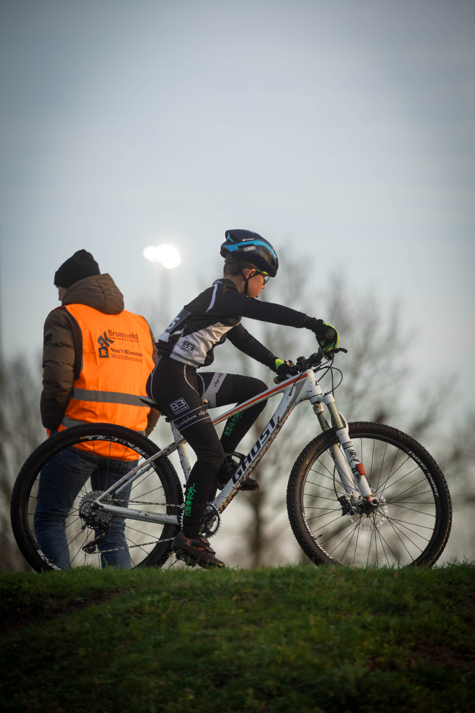 A person in a blue helmet riding a bike with the word Cycling on it.