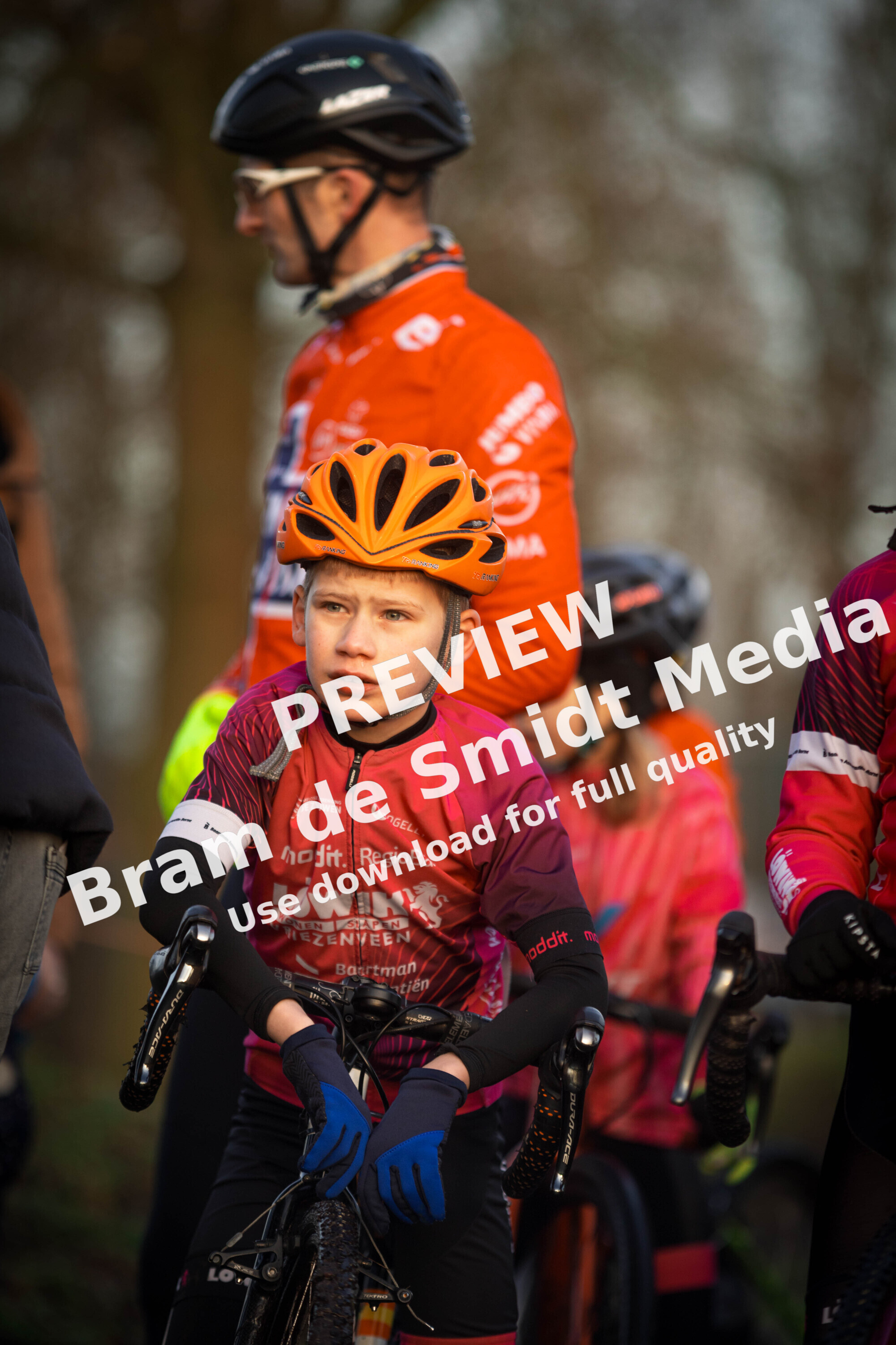 Three young boys on bikes wearing bike gear and one with a GOW shirt.