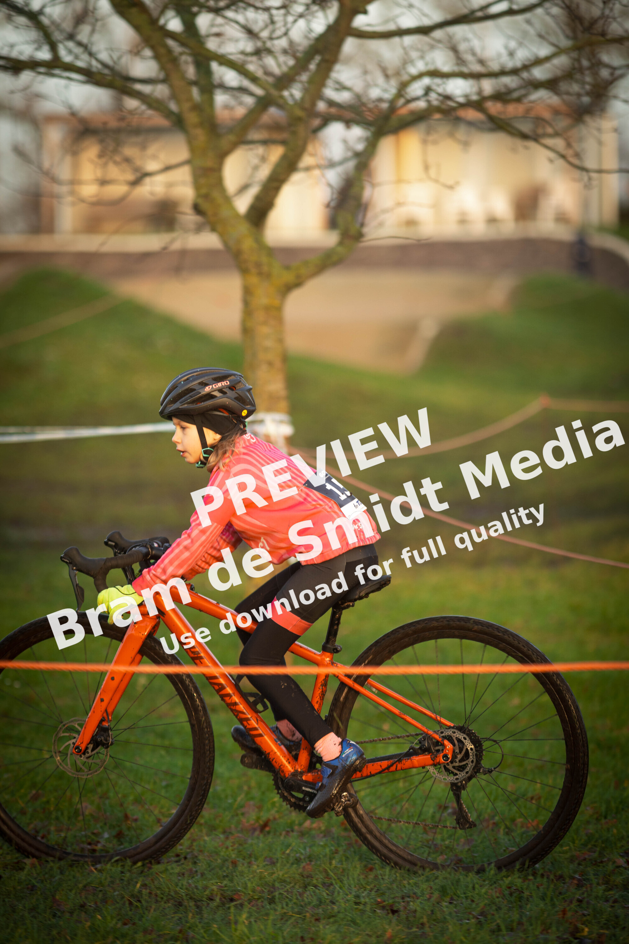 A child is riding a mountain bike that has the number 8 on it.