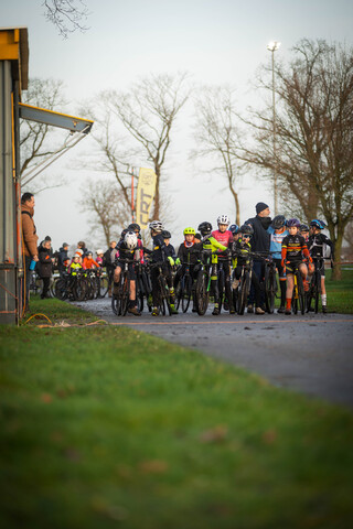 A group of cyclists on a road, one with the number 1 on their shirt.