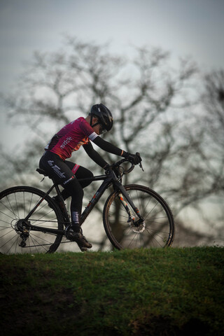 A person is riding a bike with a number 1 and 2 on the back.