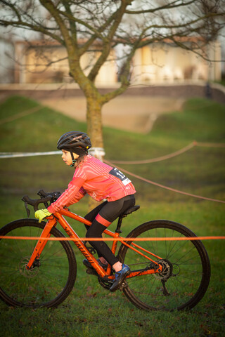 A child is riding a mountain bike that has the number 8 on it.