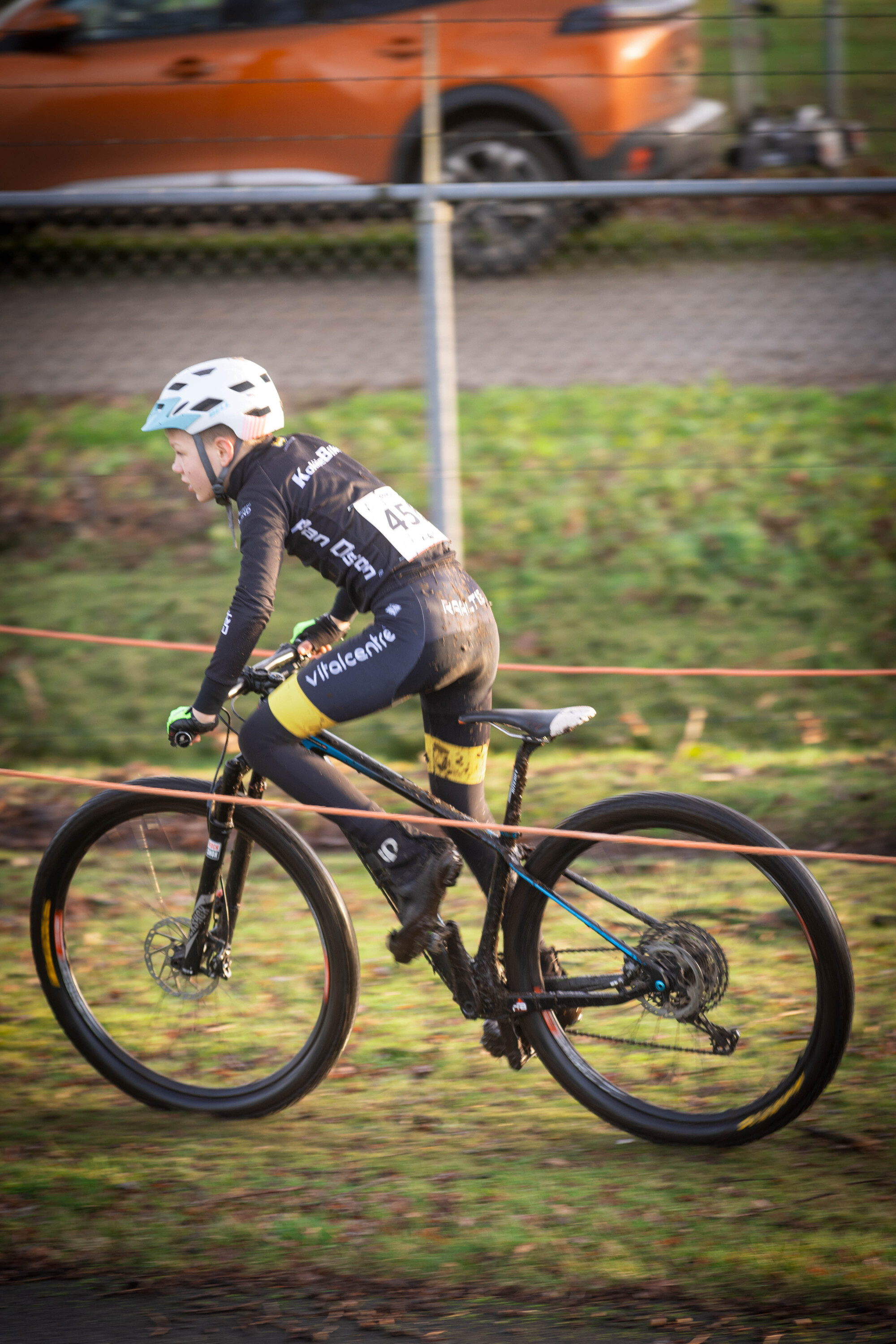 A woman on a bicycle with the number 3 on her back.