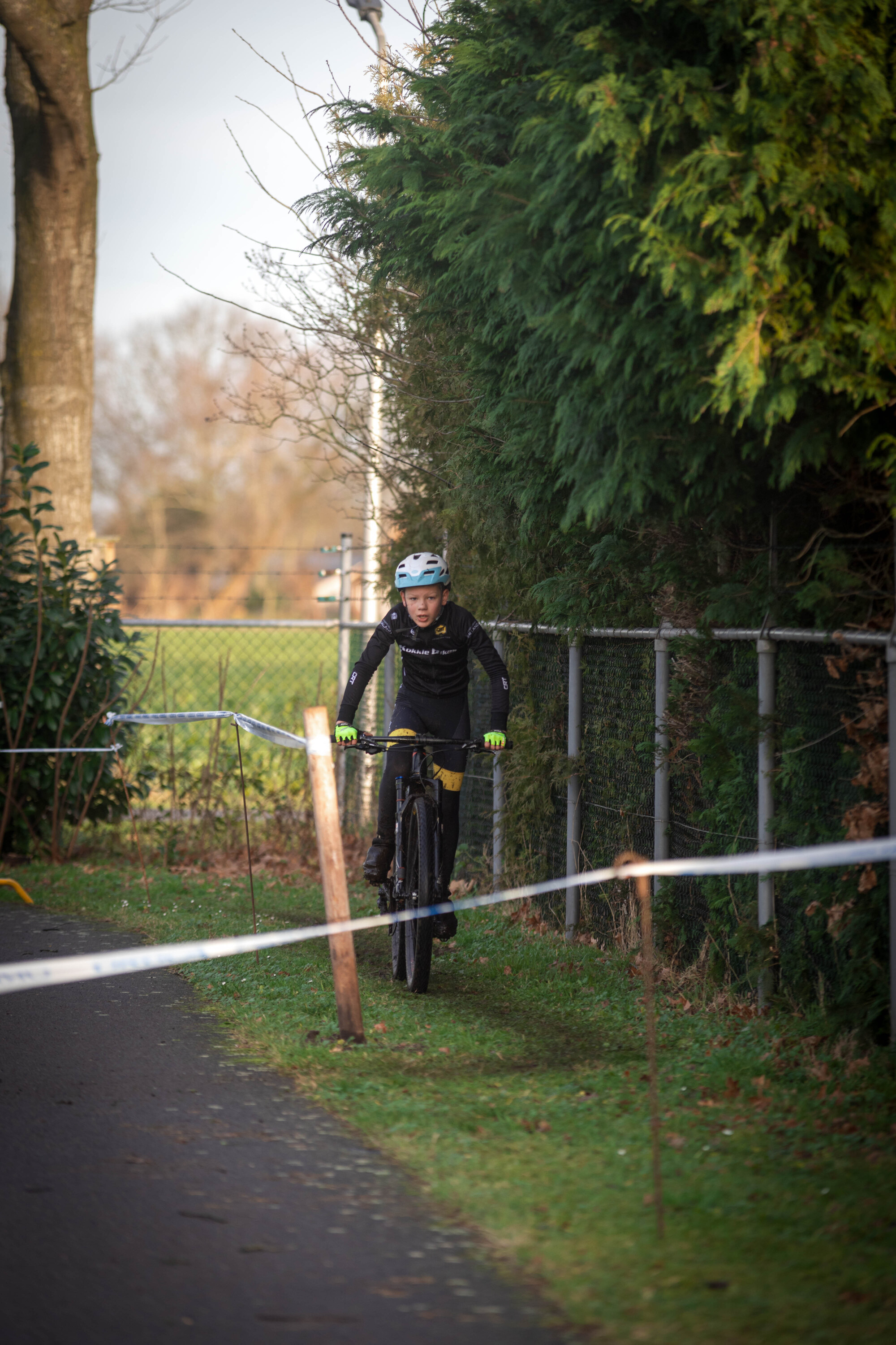 A person riding a bike down a path with no helmet.