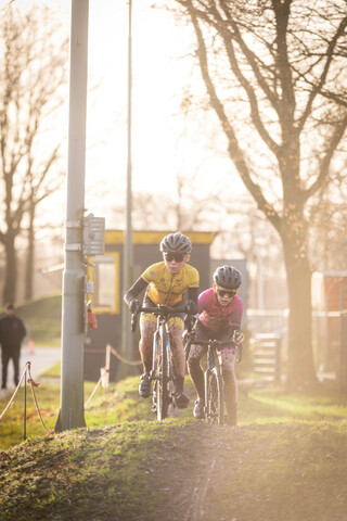 Two cyclists on a path near a sign that says "Cyclocross".