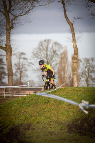 A young man is riding a bicycle in an obstacle course.