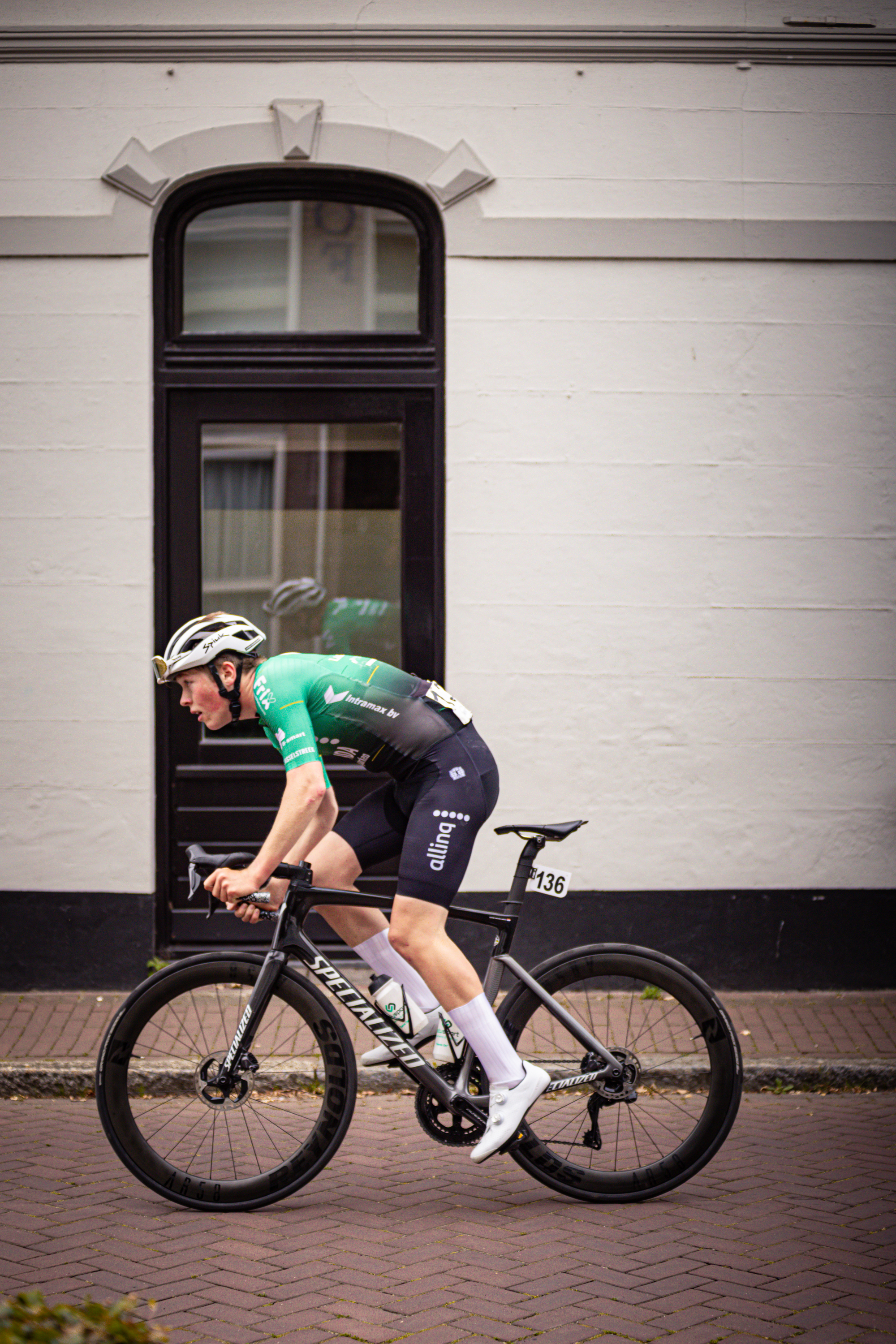 A man on a bicycle with the number 10 on his shirt.