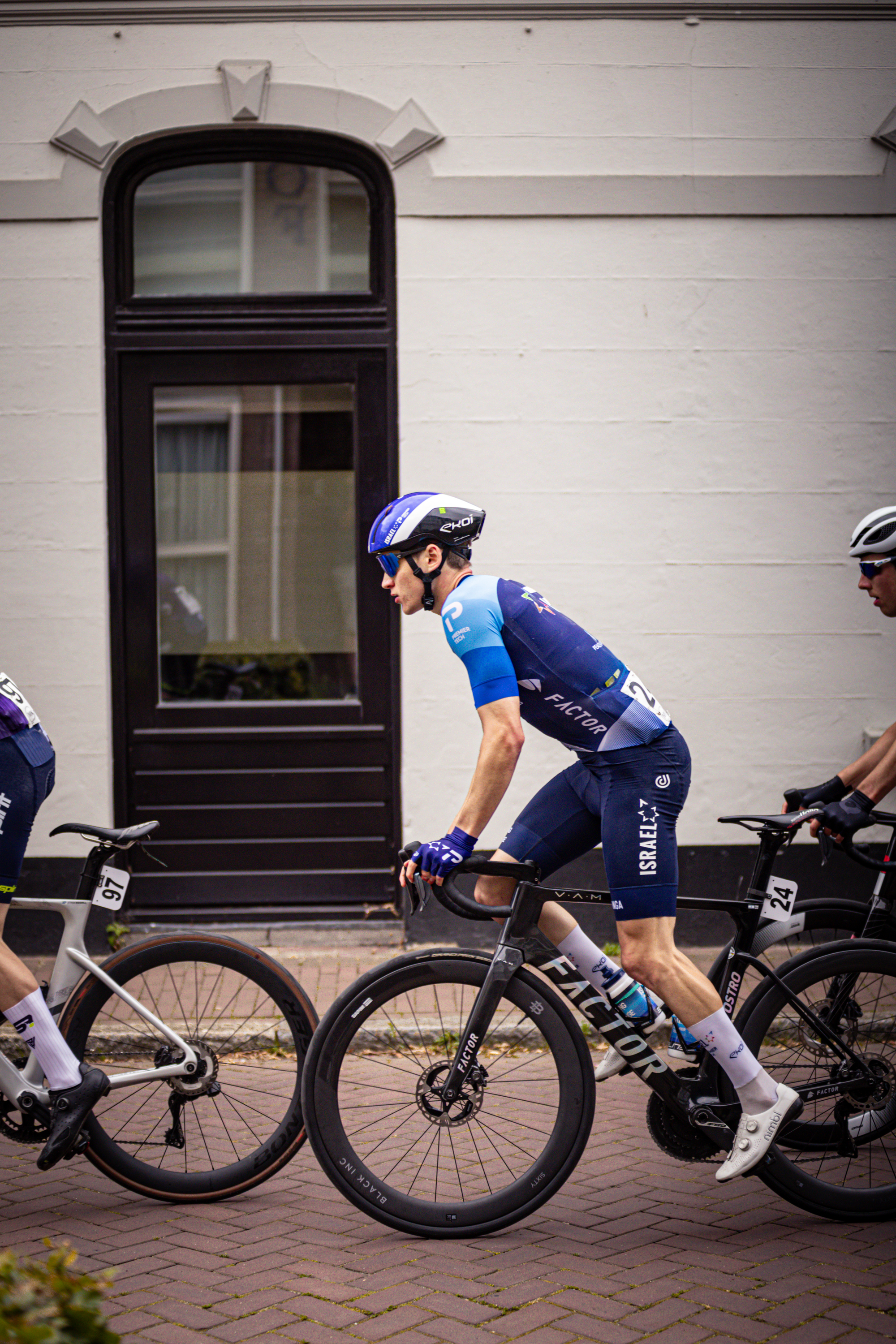 Three cyclists on the street during Midden Brabant Poort Omloop.