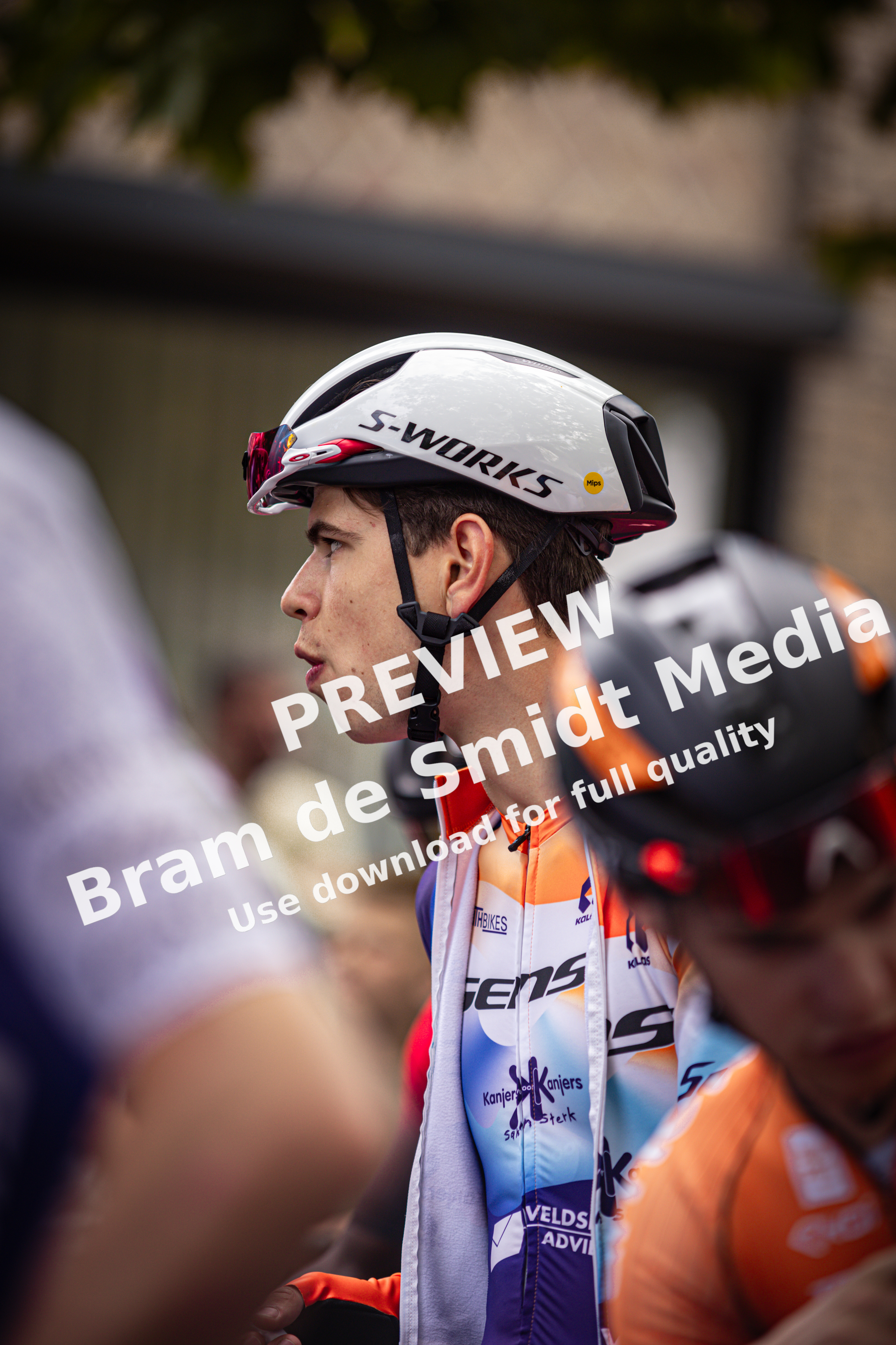 Two men are wearing helmets and cycling clothes. One of them has the word S-WORKS on his helmet.