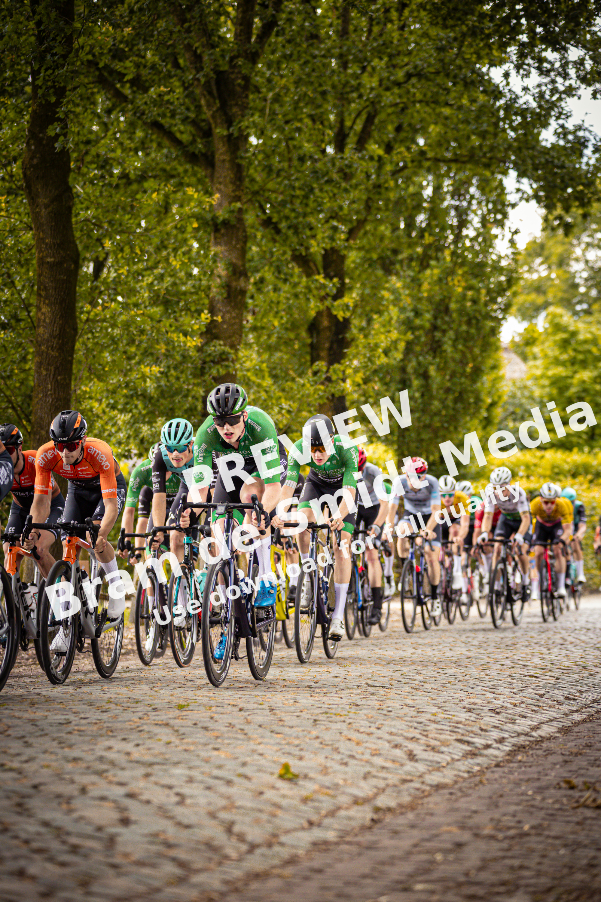 The cyclists in the image are participating in the Midden Brabant Poort Omloop, a cycling event held in 2024.