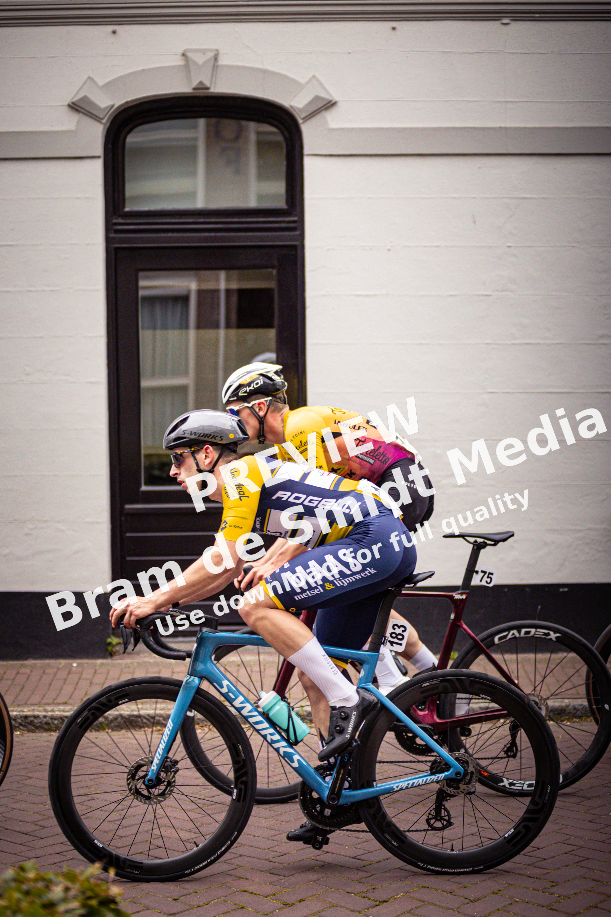 Two cyclists are racing in a race that is taking place during the Midden Brabant Poort Omloop.
