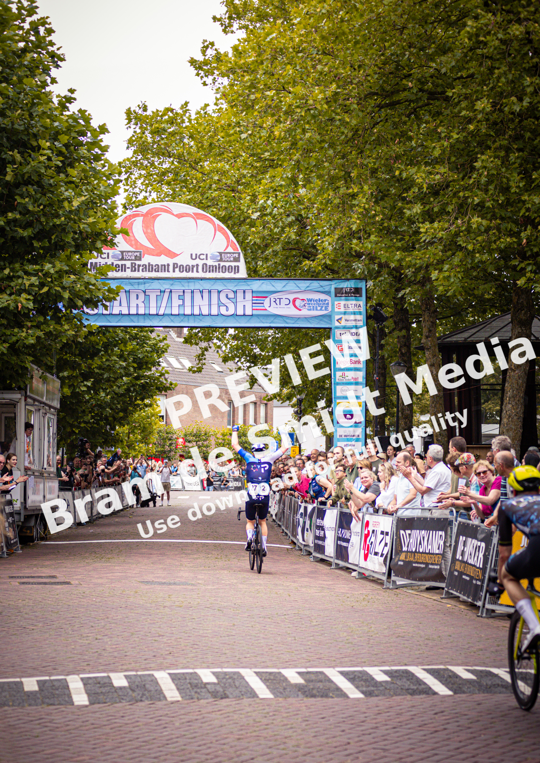 A cyclist crossing the finish line at Midden Brabant Poort Omloop in 2024.