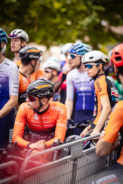 Group of cyclists on a street for the Midden Brabant Poort Omloop race.