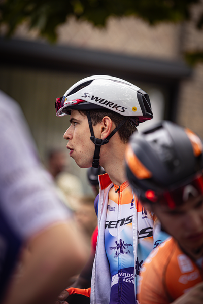 Two men are wearing helmets and cycling clothes. One of them has the word S-WORKS on his helmet.