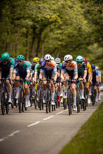 A group of cyclists race in the Midden Brabant Poort Omloop.