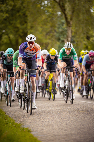 A group of cyclists participating in the Midden Brabant Poort Omloop race.