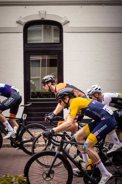 A group of cyclists are riding through the Midden Brabant Poort Omloop.