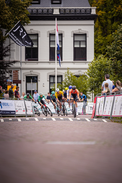 Bike race in Midden Brabant, Poort Omloop with a banner of Wielrennen.