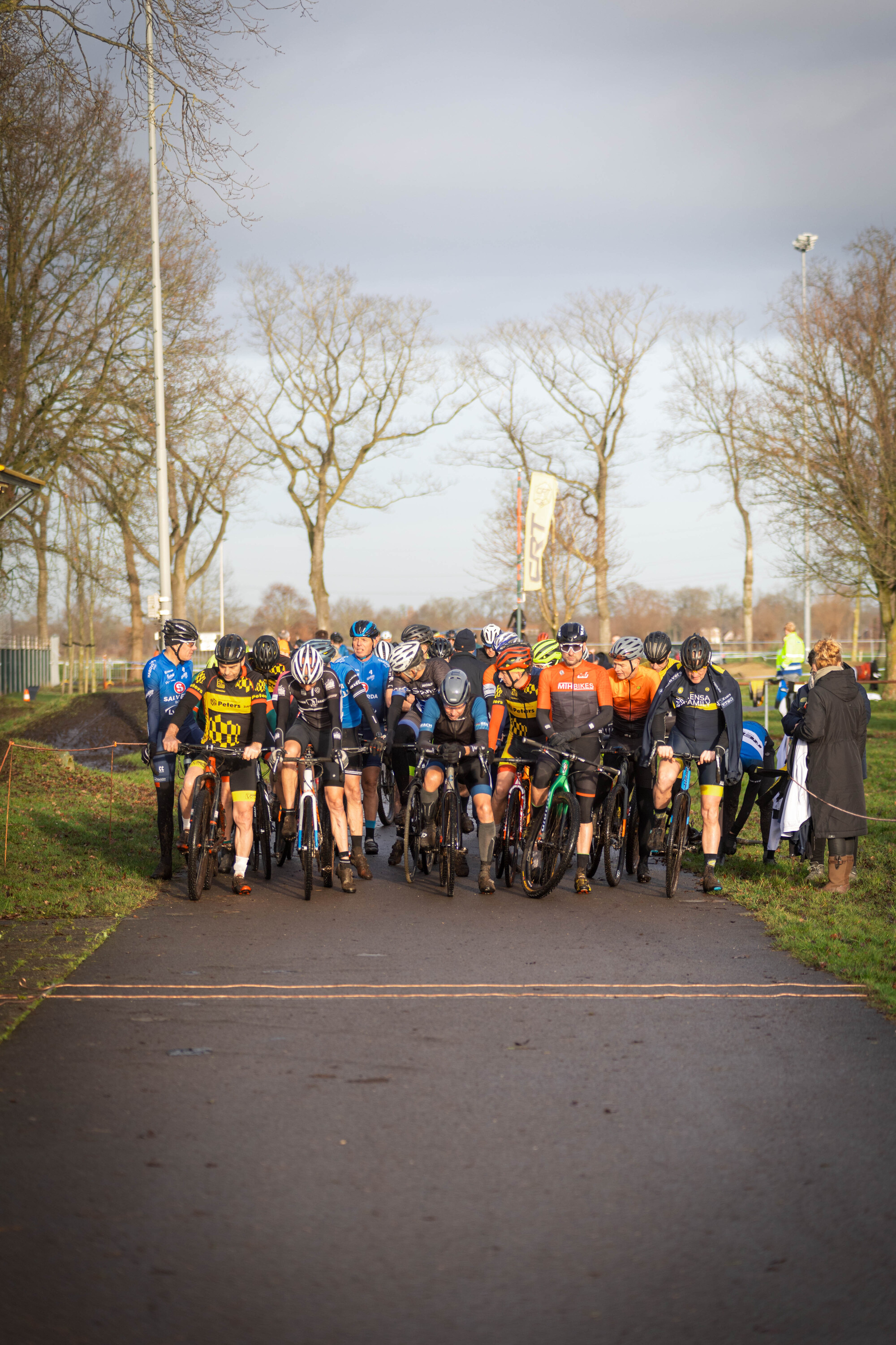 A group of cyclists are lined up for a race in Raalte.