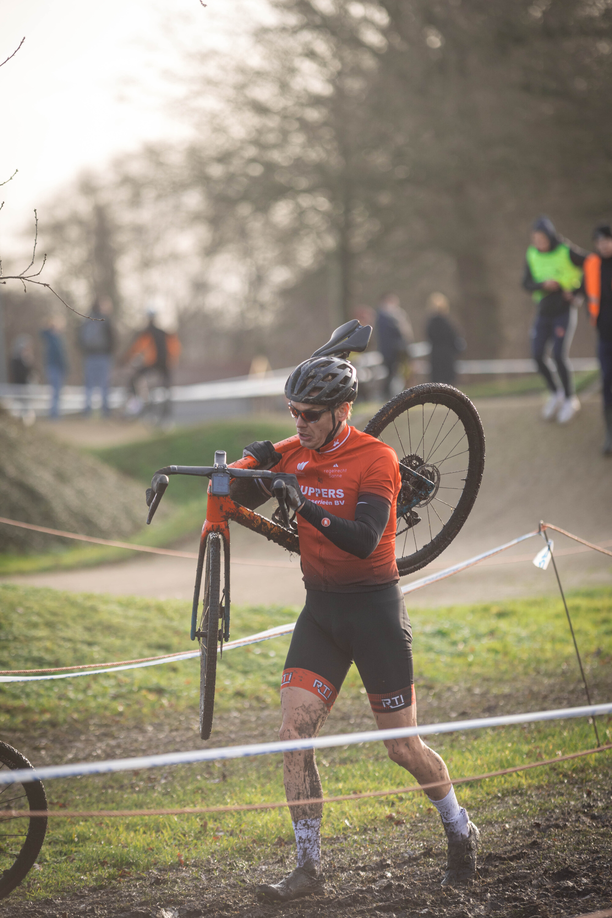 Cyclocross Masters event where a participant holding his bike and getting ready to race.