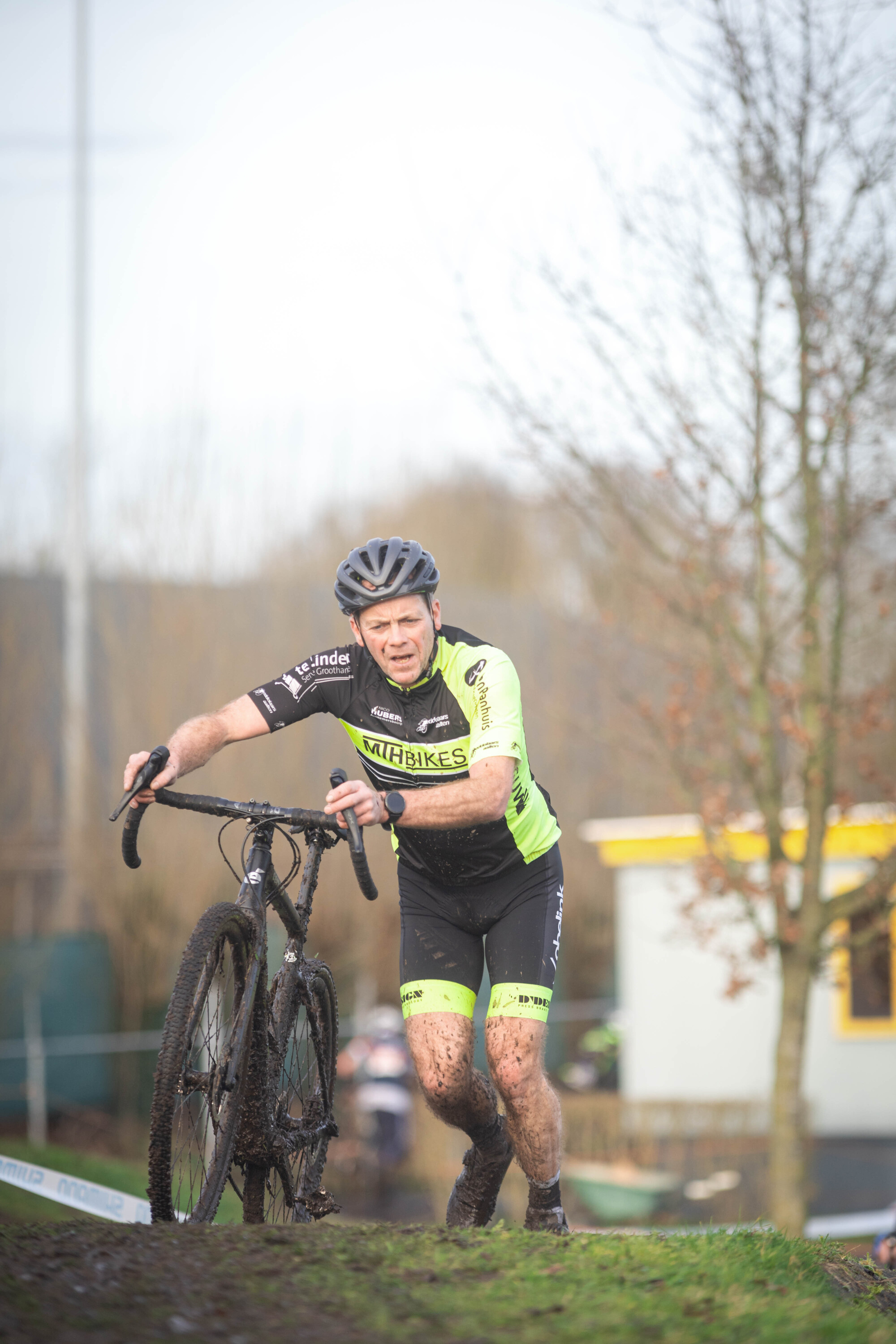 A man on a bike with the word Masters written on his uniform.