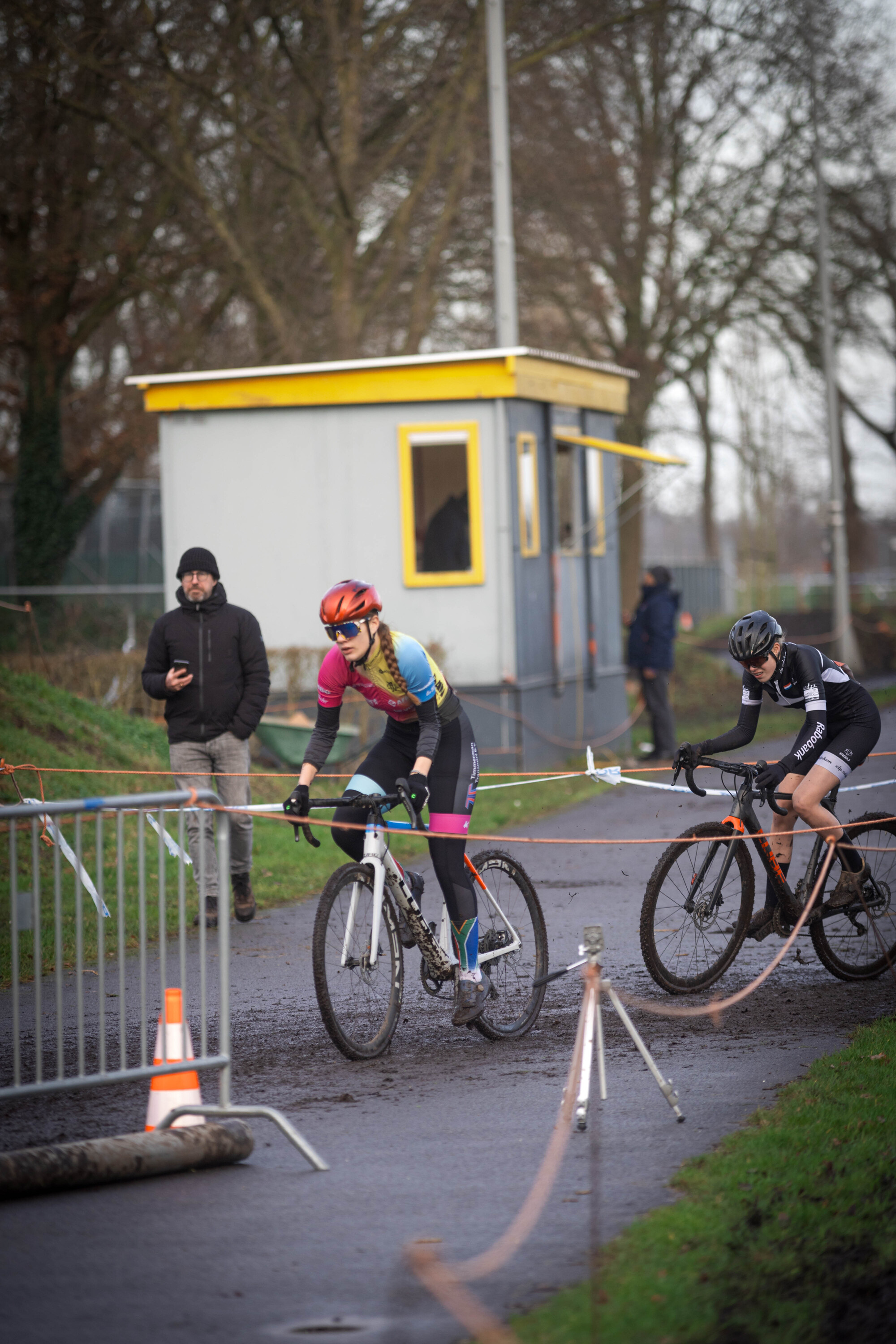 Two women racing on bikes in a cross country race.